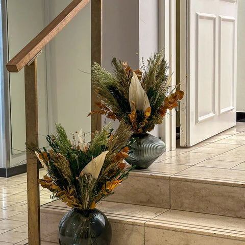 Olika vaser med buketter står i en trappa