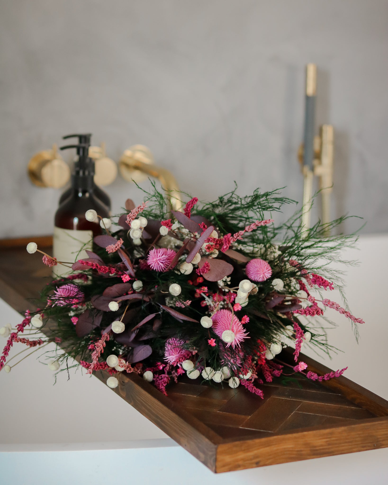 Vacker rosa blombukett ligger dekorativt på kanten av ett badkar